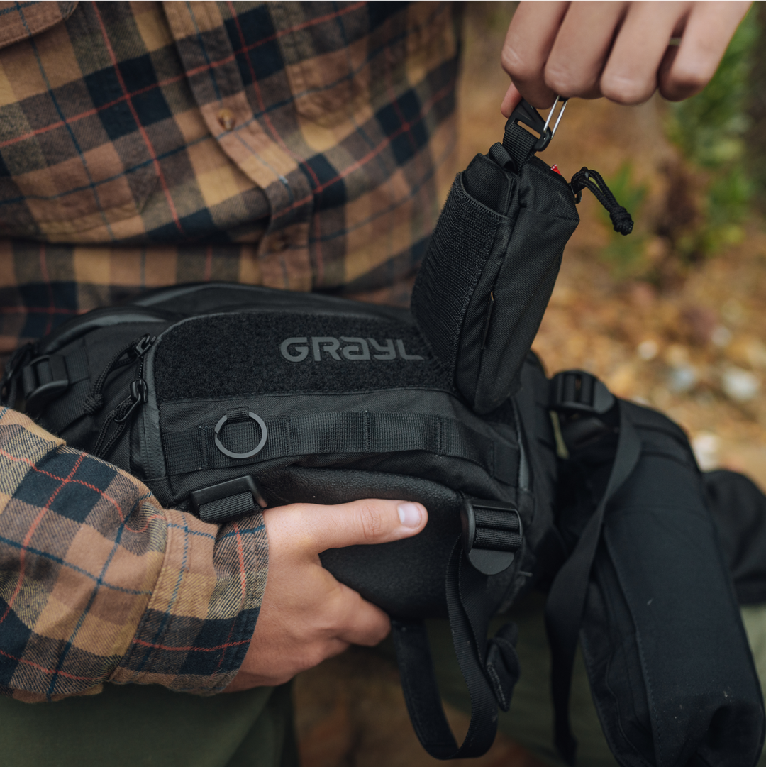 G-MOD Pod Pouch being clipped into Grayl Mission Hip Pack on the front velcro panel